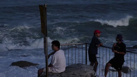 A group of young men enjoy huge waves in Sydney slow motion 4K Stock Footage 271211523