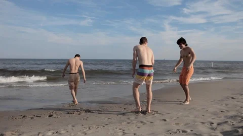 Group of Young Men Friends Having Fun in Rockaway Beach in New York Stock Footage 107404351
