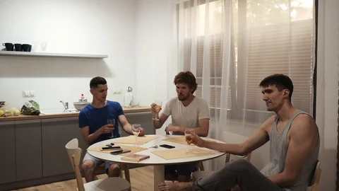Group of young men with glasses drinking in the kitchen Stock Footage 111698466