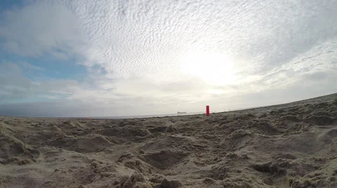 A group of young men playing flag football on the beach, slow motion. Video stock 68512871