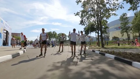 Group of young men skiing on roller ski Stock Footage 72296195