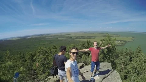 Group of young men at the top of the mountain Stock Footage 69793607
