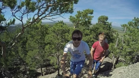Group of young men at the top of the mountain Stock Footage 69794001