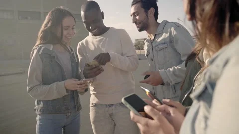 Group of young millennial friends having fun using smartphones and laughing Stock Footage 231254027