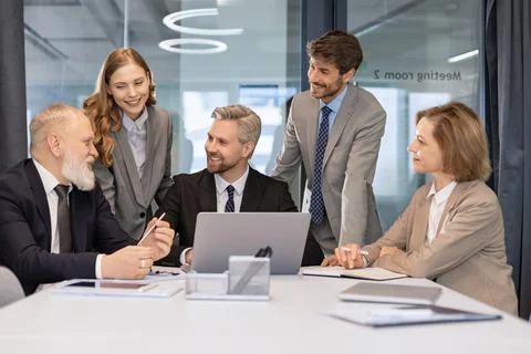 Group of young modern people using modern technologies while working Stock Photos