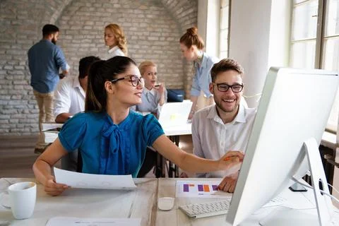 Group of young multi-ethnic startup business team collaborating on project in 스톡 사진