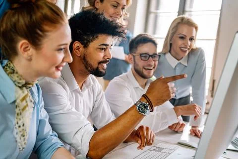 Group of young multi-ethnic startup business team collaborating on project in Stock Photos