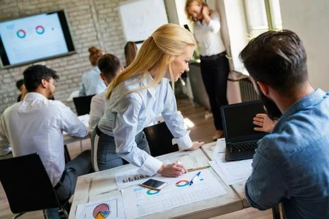 Group of young multi-ethnic startup business team collaborating on project in Stock Photos
