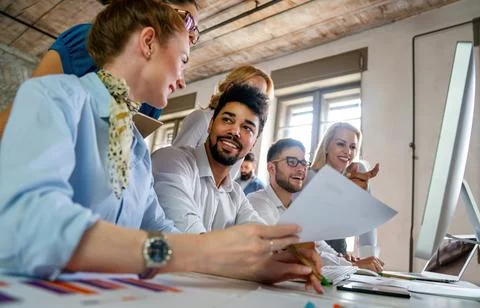 Group of young multi-ethnic startup business team collaborating on project .. Stock Photos