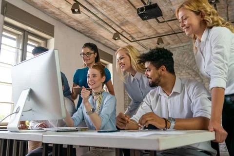 Group of young multi-ethnic startup business team collaborating on project .. Stock Photos