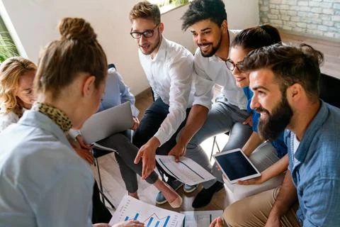 Group of young multi-ethnic startup business team collaborating on project .. Stock Photos