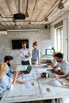 Group of young multi-ethnic startup business team collaborating on project .. Stock Photos