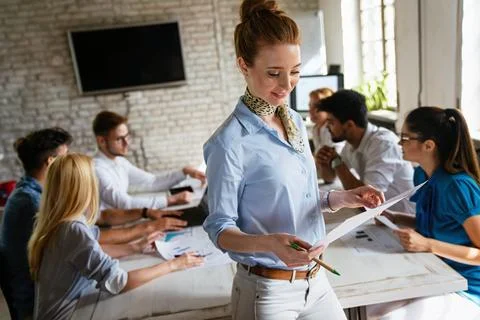 Group of young multi-ethnic startup business team collaborating on project .. Stock Photos