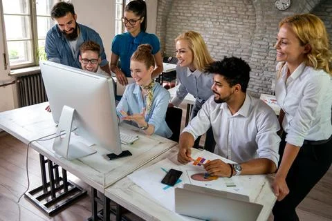 Group of young multi-ethnic startup business team collaborating on project .. Stock Photos