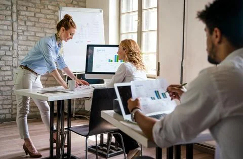 Group of young multi-ethnic startup business team collaborating on project .. Stock Photos
