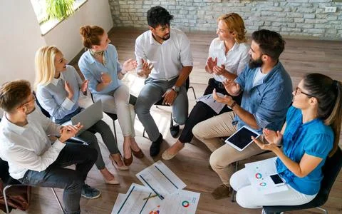 Group of young multi-ethnic startup business team collaborating on project .. Stock Photos