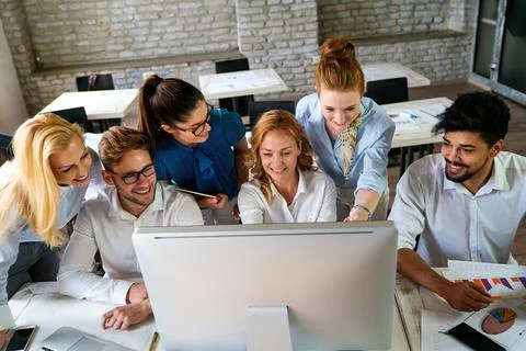 Group of young multi-ethnic startup business team collaborating on project .. Stock Photos