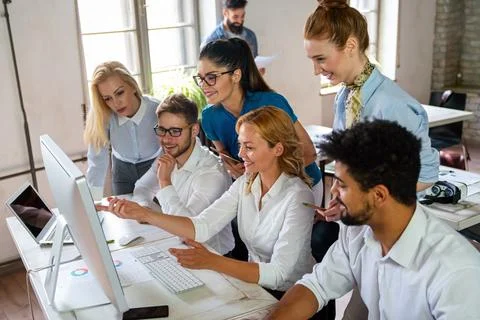 Group of young multi-ethnic startup business team collaborating on project .. Stock Photos