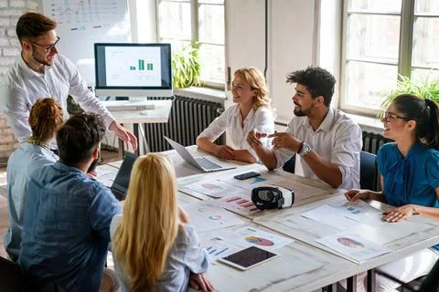Group of young multi-ethnic startup business team collaborating on project .. Stock Photos