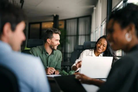 Group of young multi-ethnic startup business team collaborating on project in Stock Photos