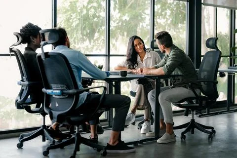 Group of young multi-ethnic startup business team collaborating on project .. Stock Photos