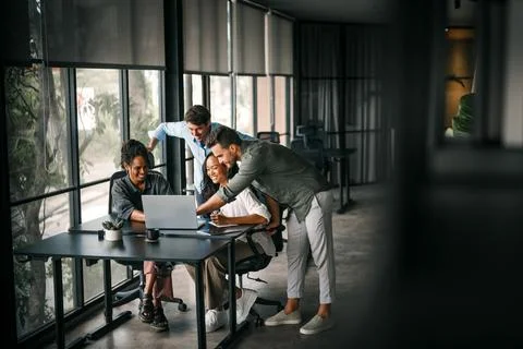 Group of young multi-ethnic startup business team collaborating on project .. Stock Photos
