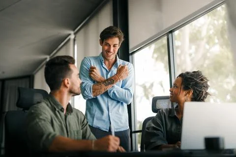 Group of young multi-ethnic startup business team collaborating on project .. Stock Photos
