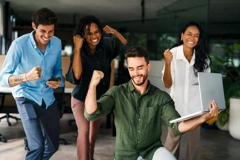Group of young multi-ethnic startup business team collaborating on project in Stock Photos