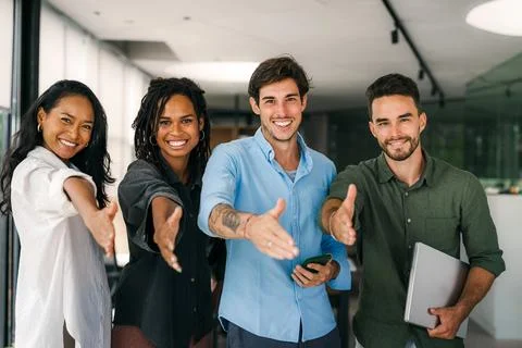 Group of young multi-ethnic startup business team collaborating on project in Stock Photos