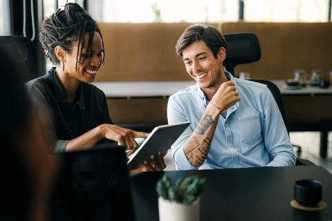 Group of young multi-ethnic startup business team collaborating on project in Stock Photos