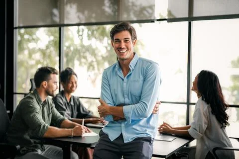 Group of young multi-ethnic startup business team collaborating on project in Stock Photos