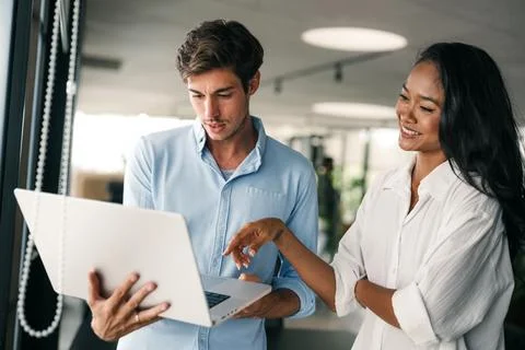 Group of young multi-ethnic startup business team collaborating on project in Stock Photos