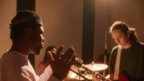 Group of Young Multiethnic Musicians Practicing New Song in Studio 库存影片 334387939