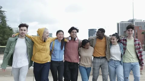Group of young multiracial friends hugging each other while walking outdoors Stock Footage 170795667