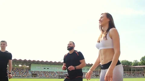 A group of young people are doing fitness at the stadium with slamball. Stock Footage 130801357
