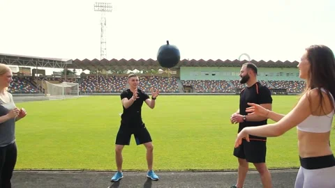 A group of young people are doing fitness at the stadium with slamball. Stock Footage 130801361