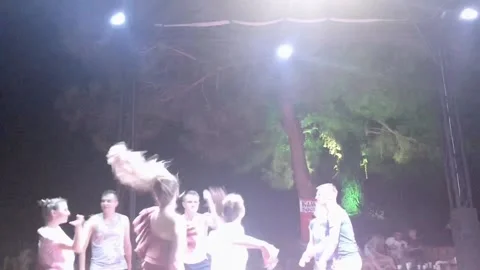 A group of young people dancing at a beach night party. Stock-Footage 129515715