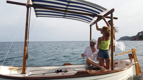 A group of young people dancing in a boat at the mediterranean sea Stock Footage 115439674