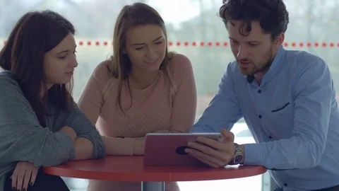 Group of young people discussing a project during an informal meeting Stock Footage 75556779