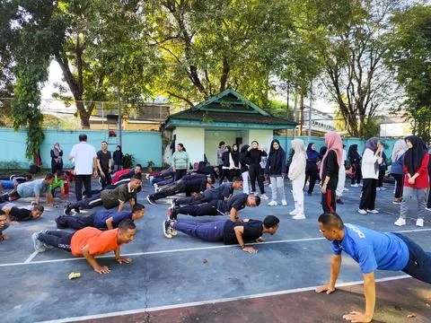 Group of Young People Doing Push Ups and Physical Exercise on Outdoor Sports Cou Stock Photos