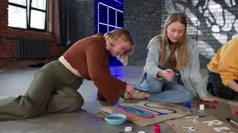 A group of young people draw posters and protest against environmental pollution Stock Footage 233219855