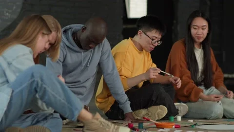 A group of young people draw posters and protest against environmental pollution Stock Footage 233220858