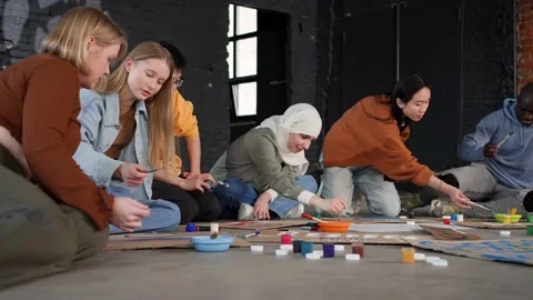 A group of young people draw posters and protest against environmental pollution Stock Footage 233221093