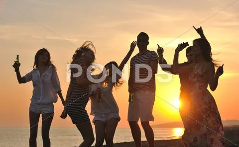 Group of young people enjoy summer party at the beach Stock Photos
