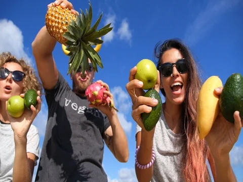 Group of Young People Having Fun With Fruits Against Blue Summer Sky Stock-Footage 75823701