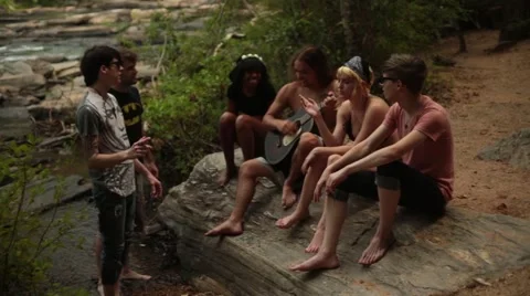 Group of young people jamming out in the woods Stock Footage 44672825