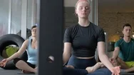 Group Of Young People Meditating In A Yoga Classroom Stock Footage