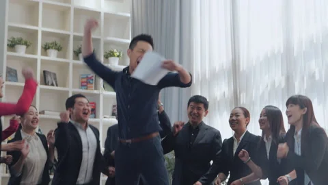 A group of young people in the office clapping and cheering celebrating success Stock Footage 141457629