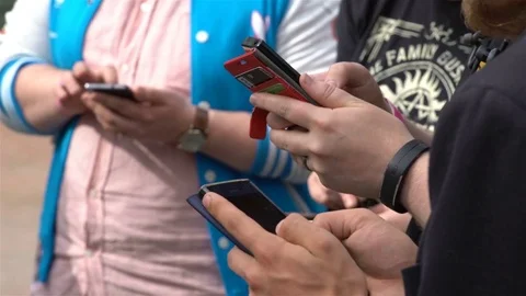 A group of young people play mobile games on your phone via Wifi network Video stock 80447013