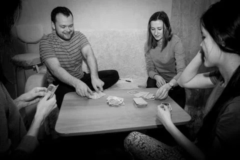 Group of young people playing cards Stock Photos